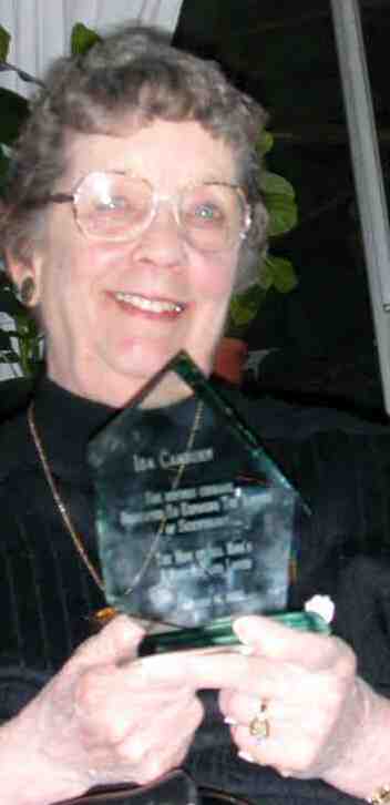 Ida Camburn proudly displays her Award from ex-cult members - It states: Ida Camburn - She defines courage - Dedicated to exposing the abuses of Scientology 